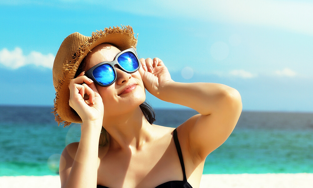 Woman on beach in sunglasses