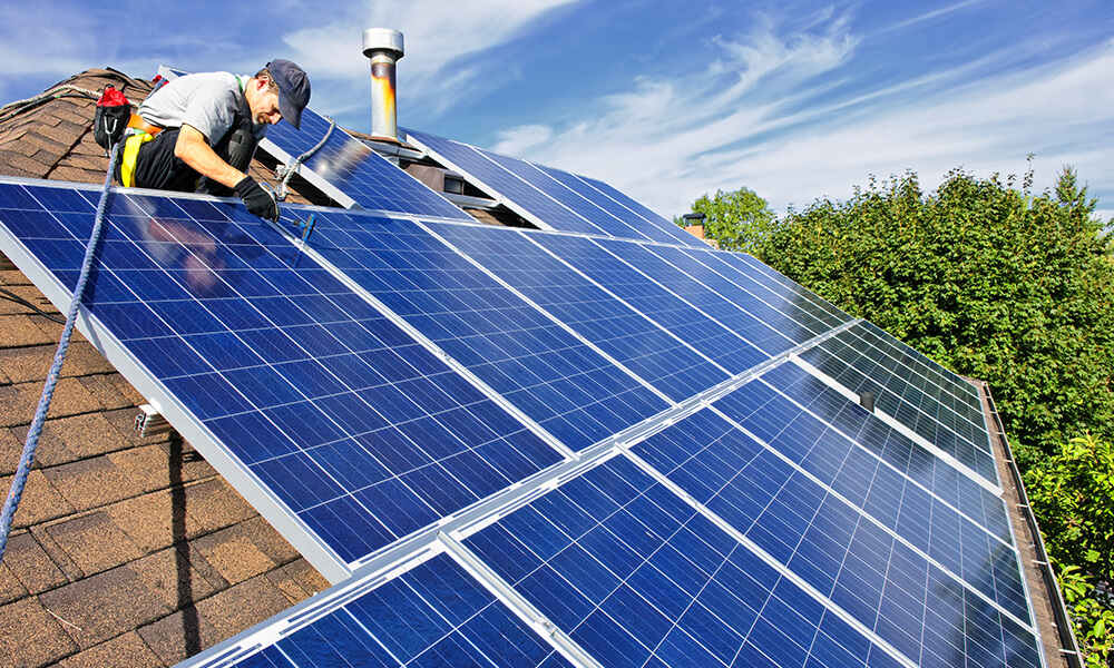 solar panel expert installing solar panels on house roof