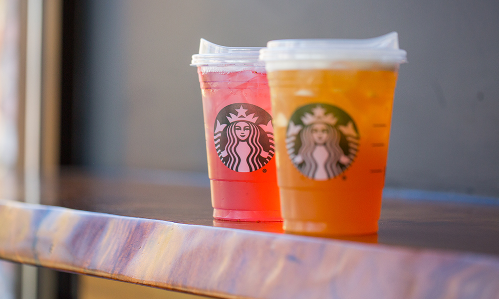 two iced Starbucks drinks with their new lids that don't need straws
