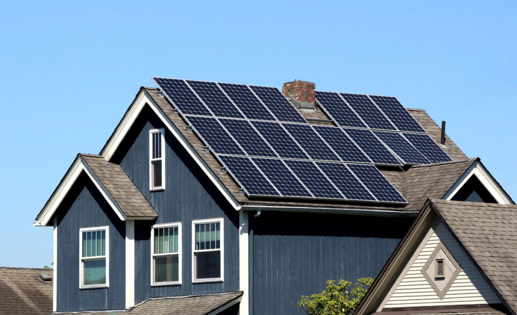 blue house with solar panels