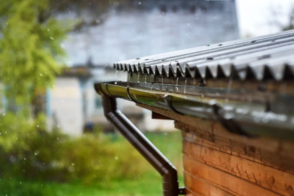 dark metal gutter system installed on nebraska home