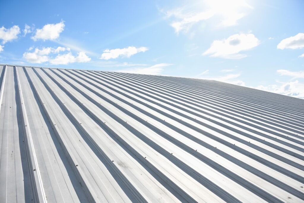 metal sheet roofing on new construction with blue sky