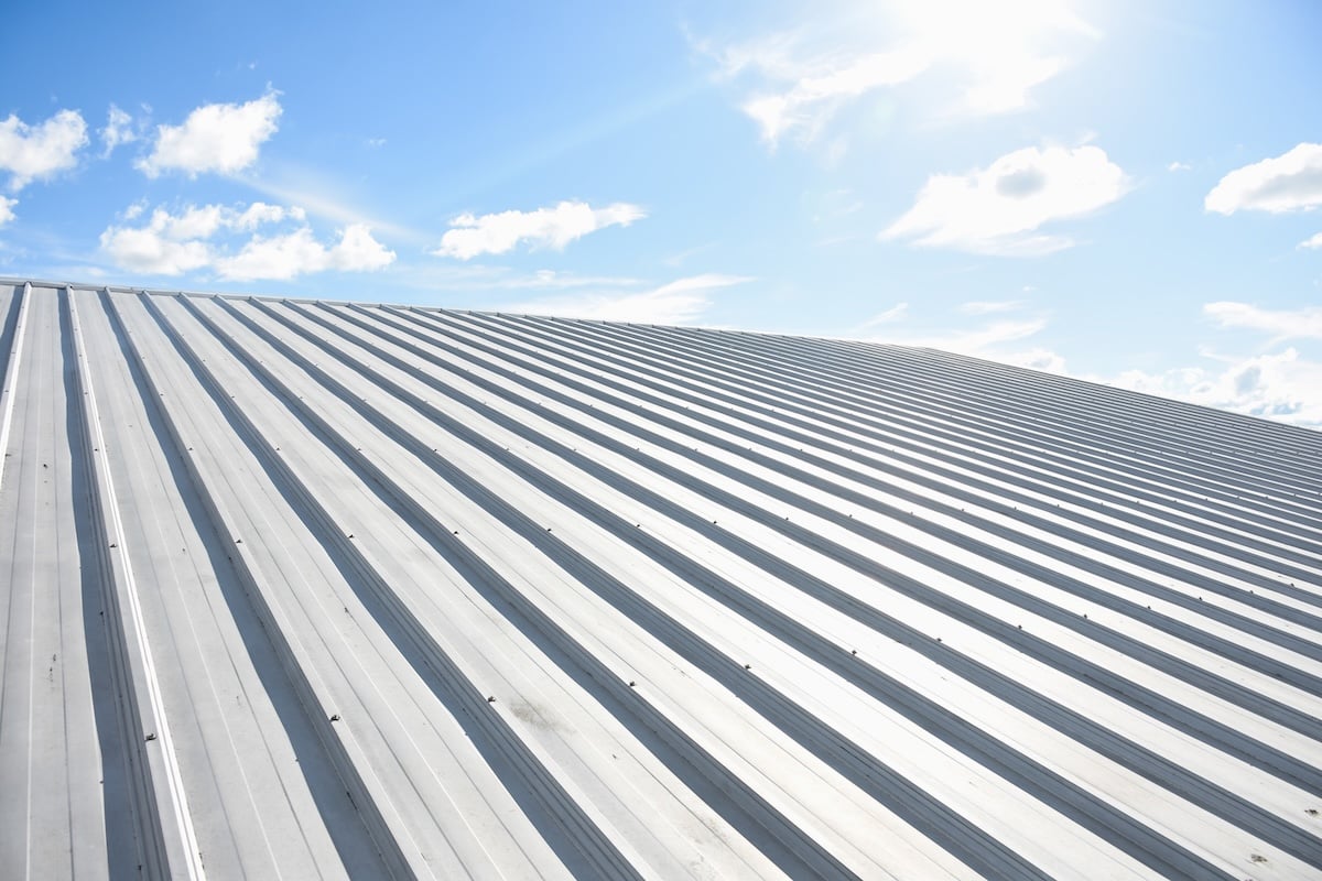 metal sheet roofing on new construction with blue sky