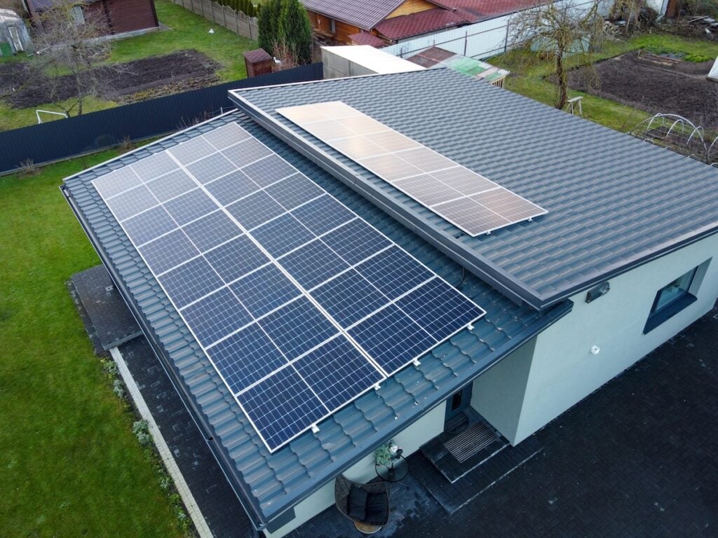 Solar panels on pitched metal roof. Home Renewable Energy Systems. Solar Rooftop System.