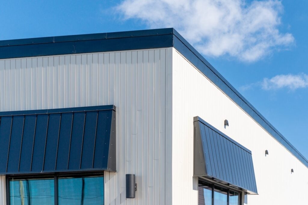 The exterior surface of an aluminum metal composite panel wall of a contemporary business.