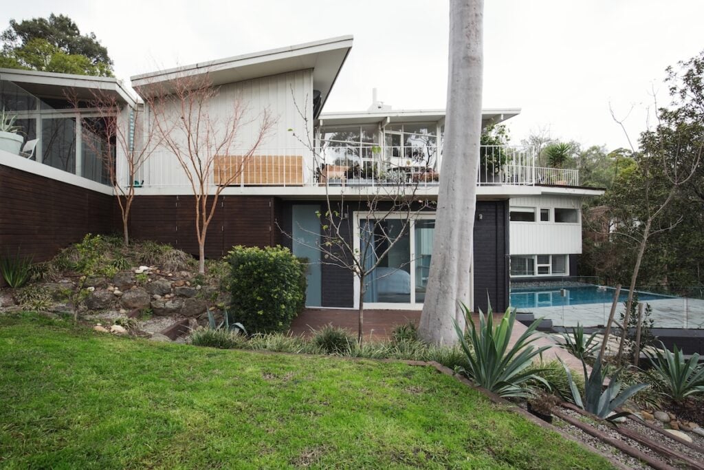 Exterior of a large mid century modern home with butterfly roof