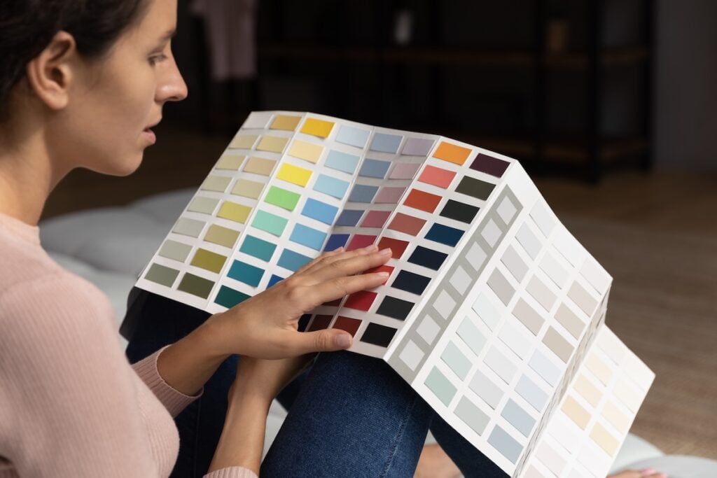 color swatch book, woman browses color options