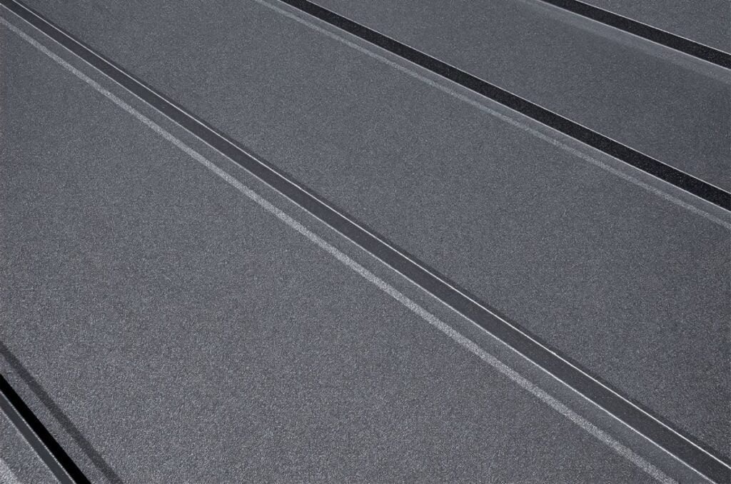 Close-up house retro roof panel with standing seam and fasteners