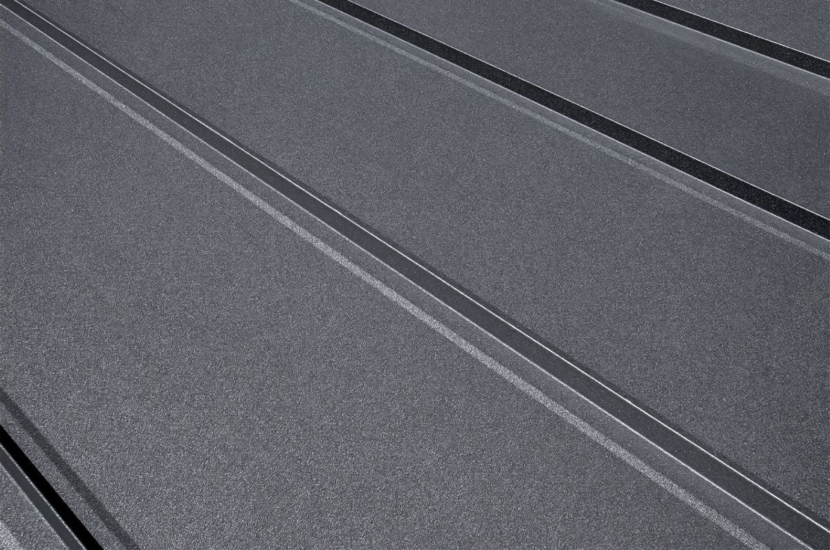 Close-up house retro roof panel with standing seam and fasteners