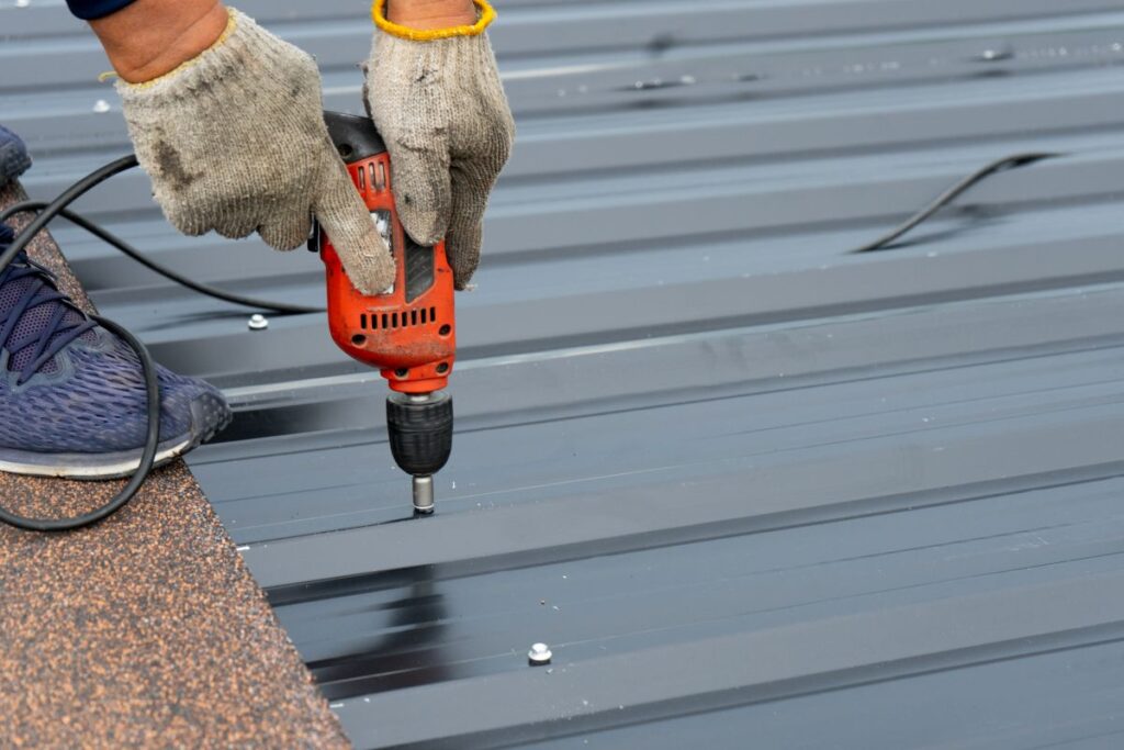 roofer installing a metal sheet roof