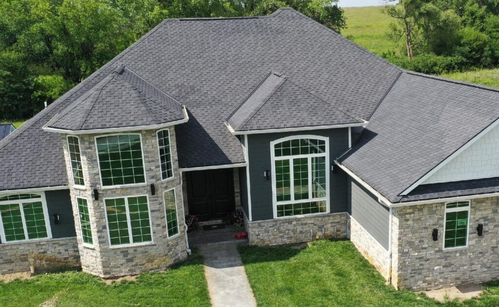 Large house with dark grey asphalt shingle roof