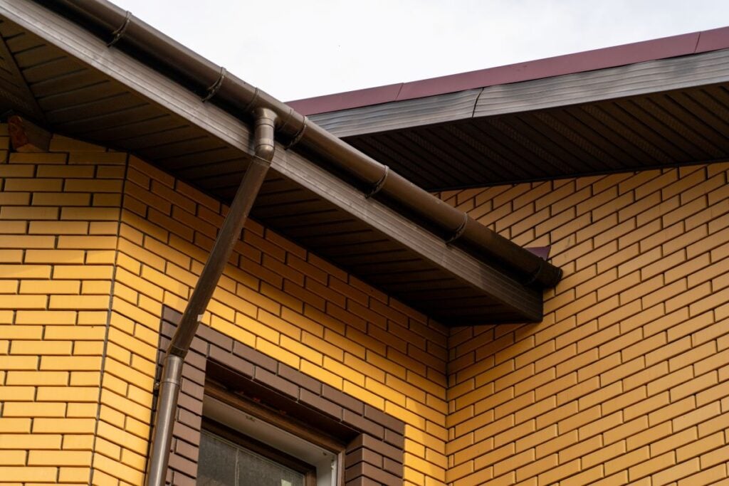 dark brown metal roof trim yellow brick wall