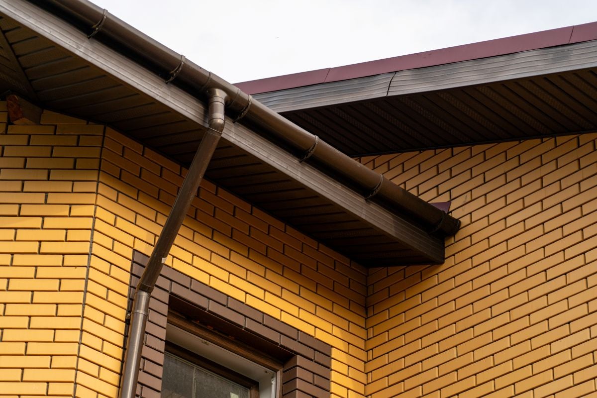 dark brown metal roof trim yellow brick wall
