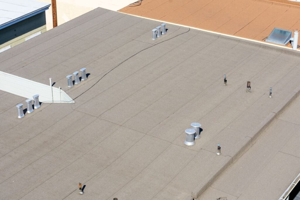 exhaust pipes on flat roof of a building
