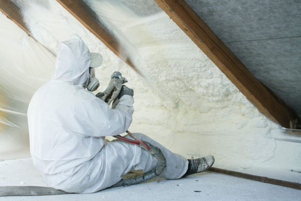 roof insulation r value roof insulation worker using tool to apply foam