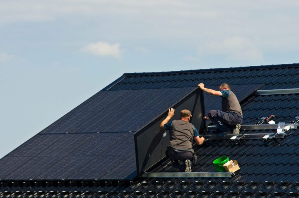 best solar panels home workers on top of metallic tiles