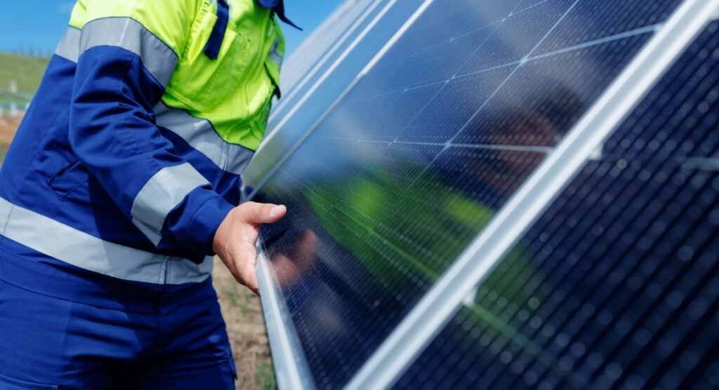 commercial solar installation worker holding pannels for building