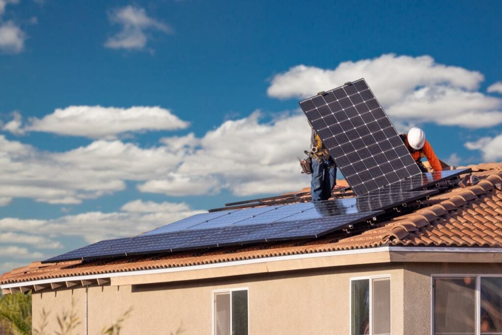 how many solar panels do i need workers installing panels on tile roof