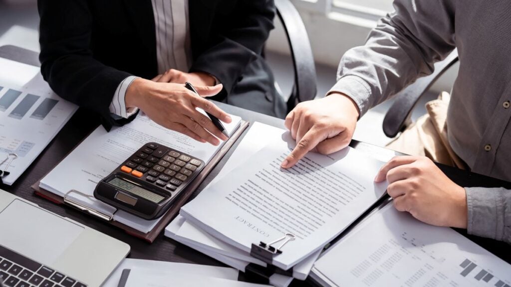 roof insurance claim process two people filling out papers