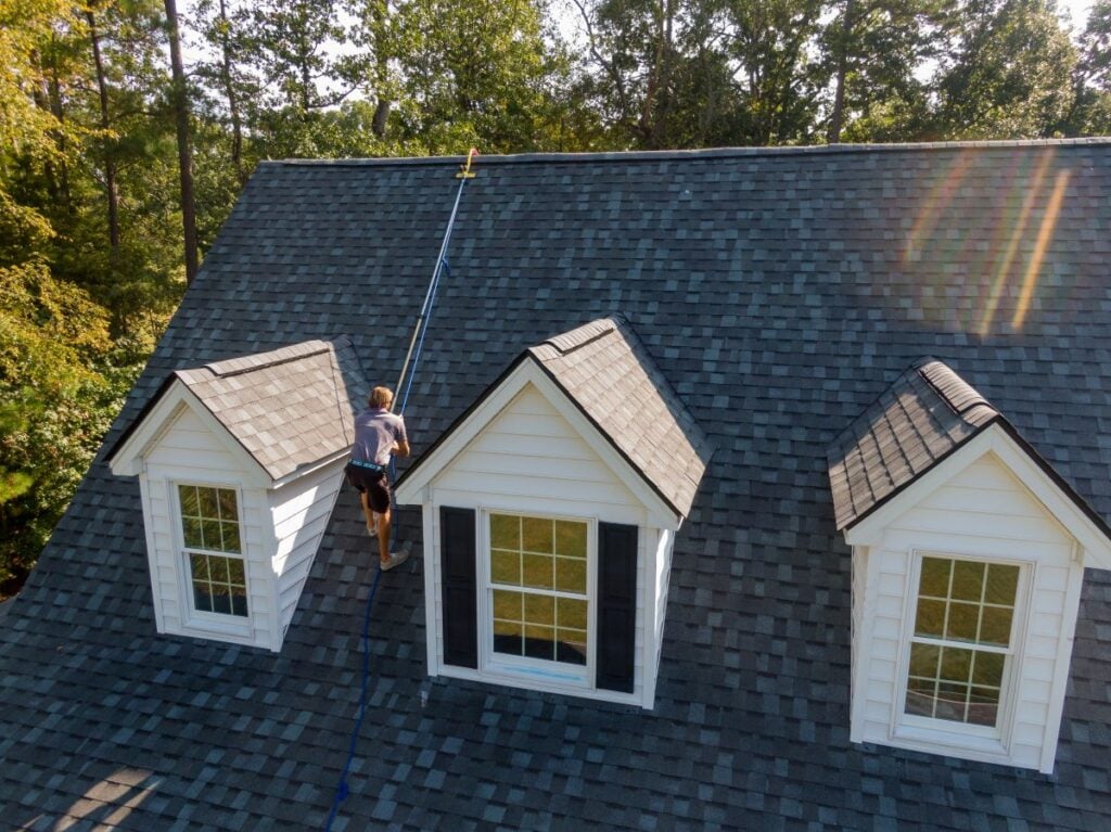 how long does a roof replacement take worker using a cable to walk on top of shingles roof