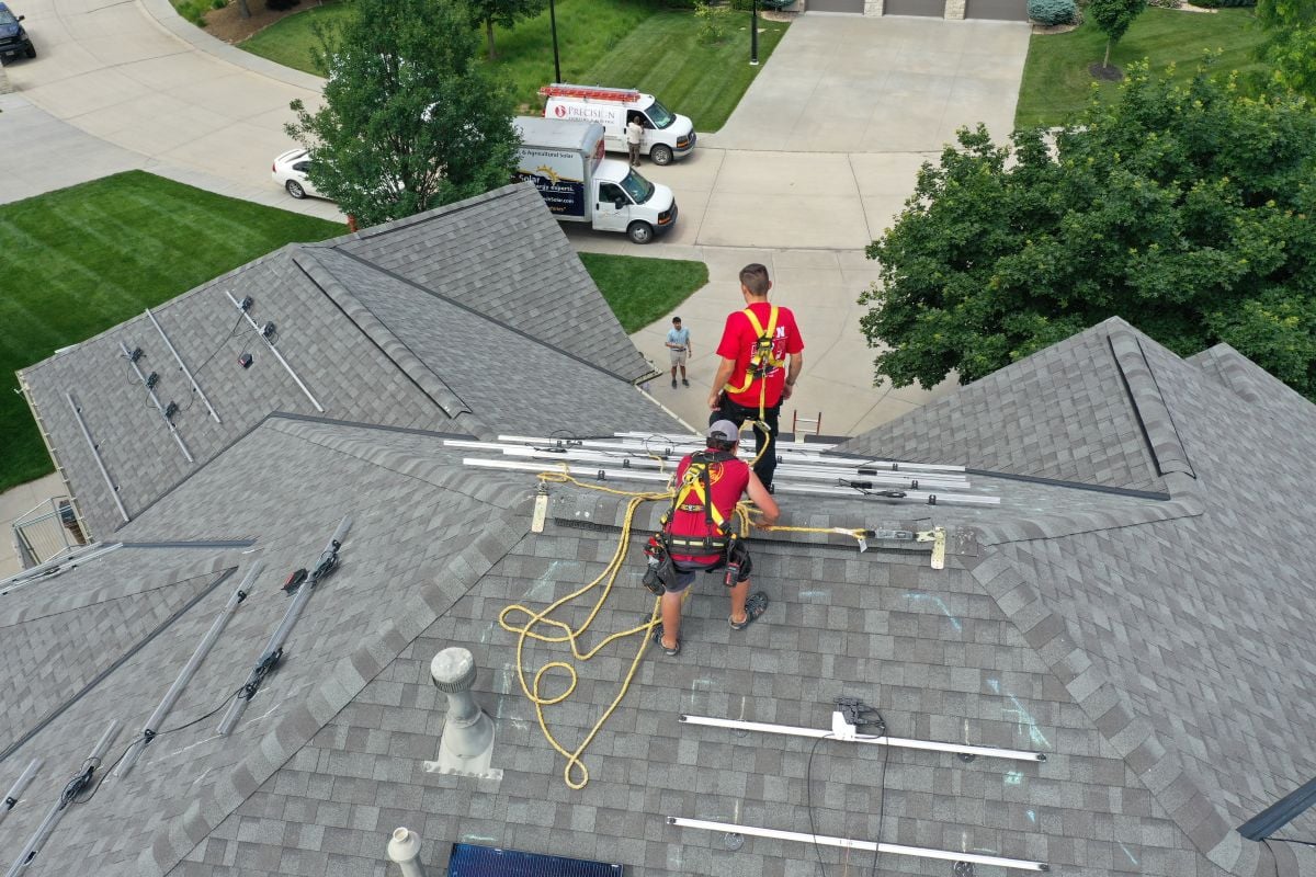 J-Tech team on a roof, installing solar panels