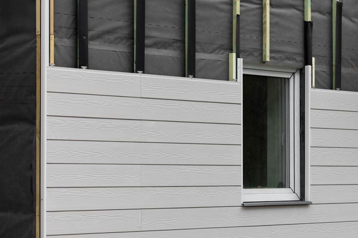 wood texture composite siding being installed