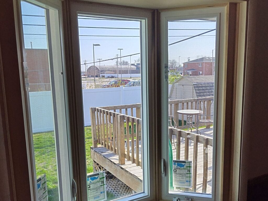 window installation cost white siding sinde view wooden deck