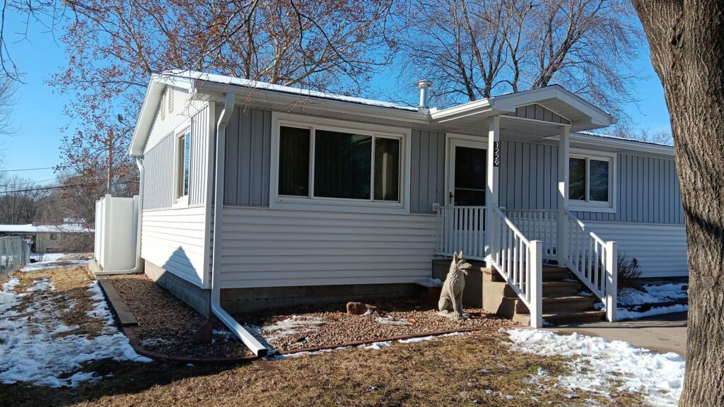 window installation cost blue sky white siding small house
