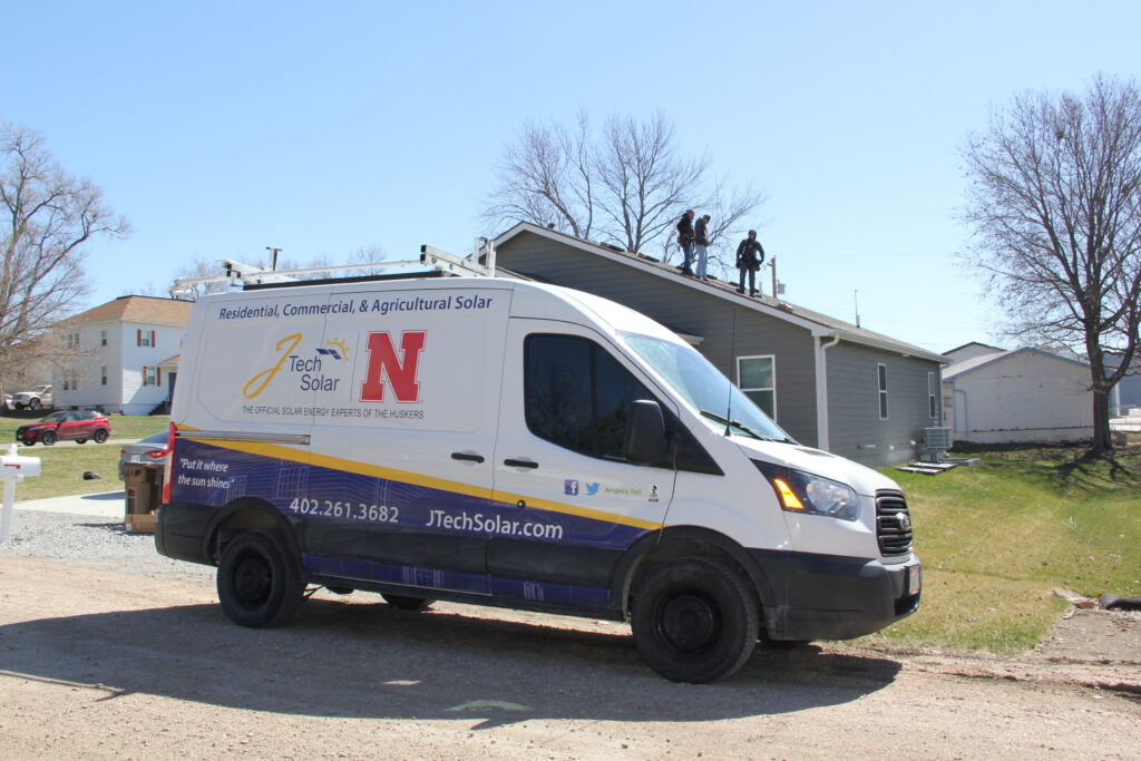gutter guard installation branded truck outside of house
