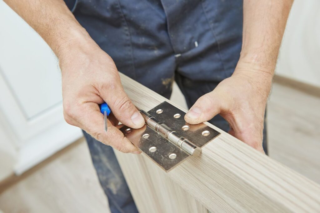 entry door replacement cost  worker replacing wooden door