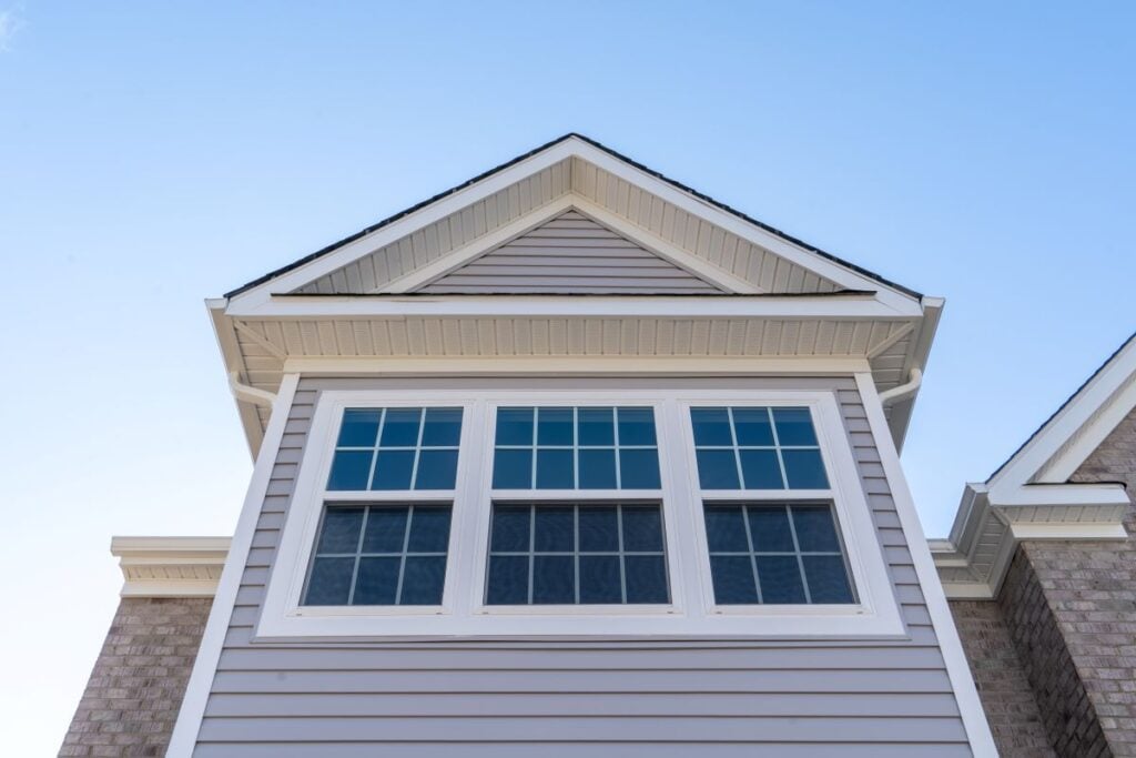 double hung vs casement windows grey siding white frame triple windows