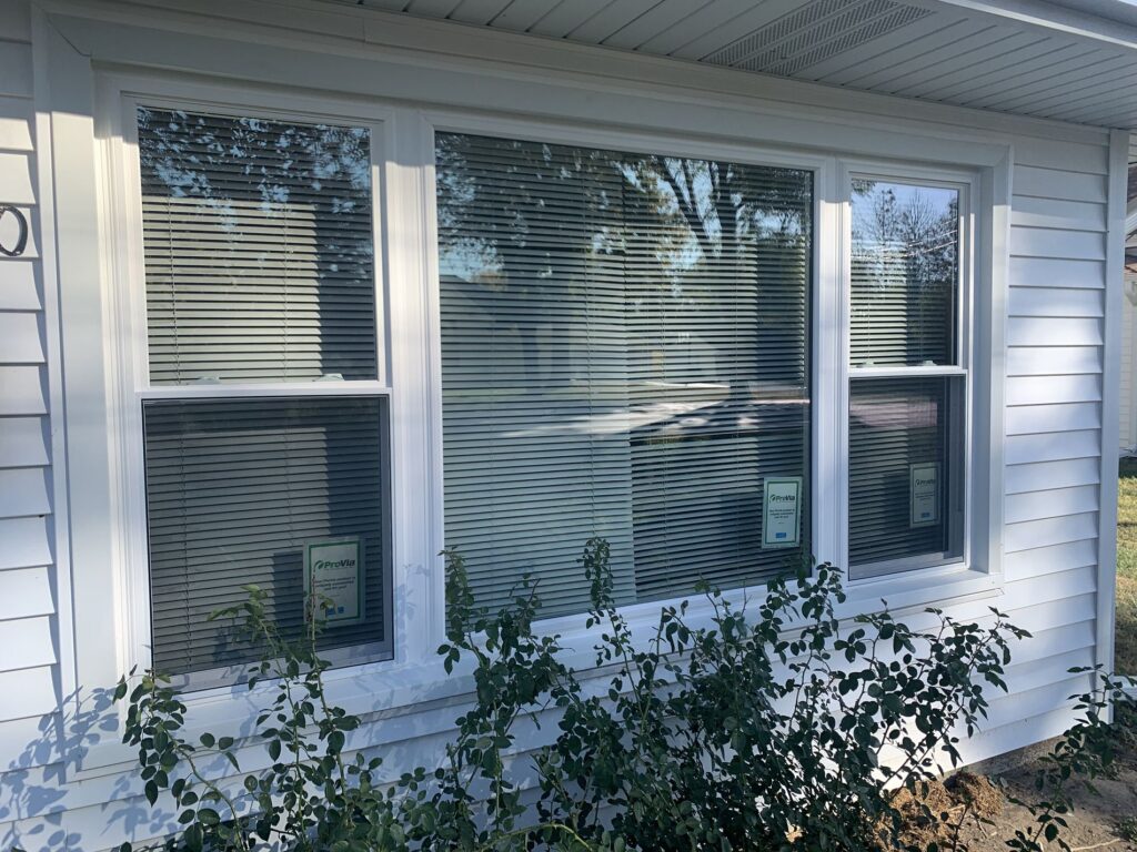 window installation cost white siding outside view
