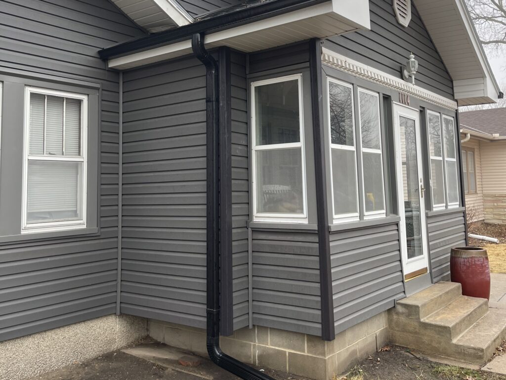 window installation cost dark grey siding winter time