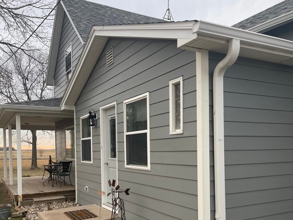 fiber cement siding vs vinyl grey house white frame