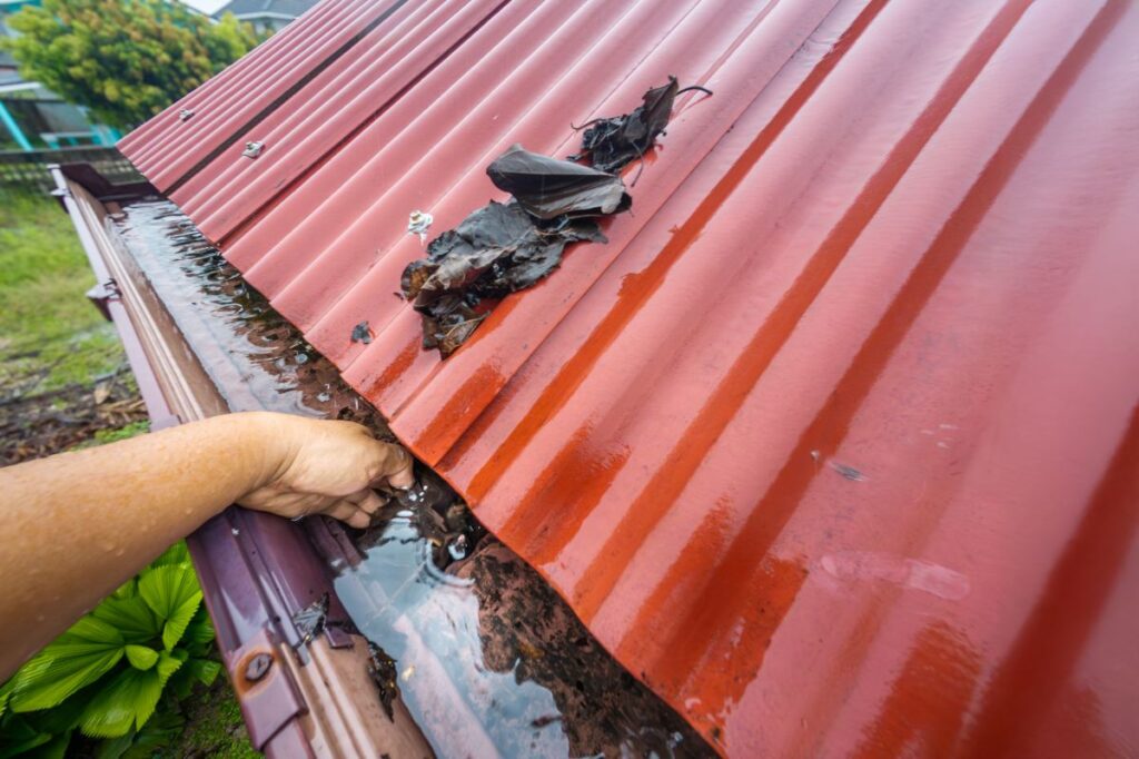 gutter guard installation red metallic roof hand cleaning water system